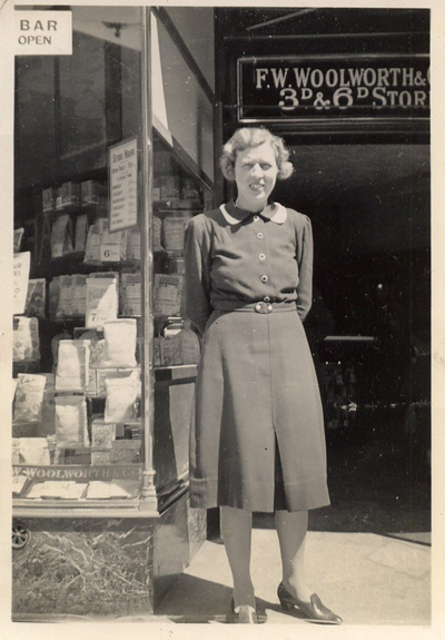 A rare picture, perhaps taken be a relative, shows an unknown sales girl outside her store in the mid 1930s. Click for a large copy.