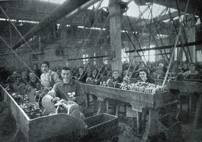 Factory workers making tobacco pipes for sale in the Threepenny and Sixpenny Stores of F. W. Woolworth and Co. Ltd. in the UK in the 1930s. Click for a larger version in a new window.